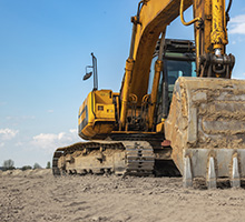 Large excavator clearing land in Broward County