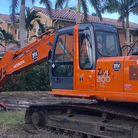Mike Mann Excavator clearing land on west palm beach neighborhood