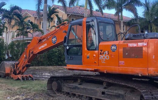 Mike Mann Excavator clearing land on west palm beach neighborhood