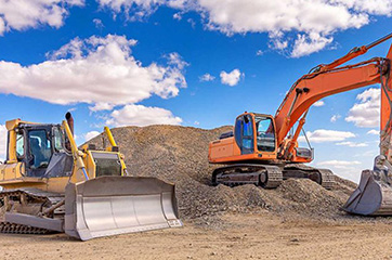 Excavator nd bulldozer next to each other